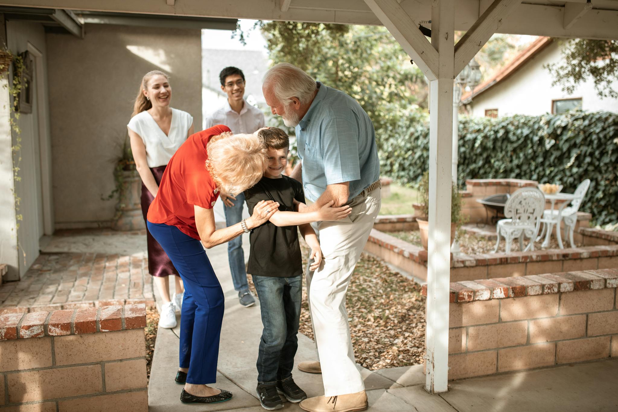 Multi-generational family sharing a joyful moment on the patio.